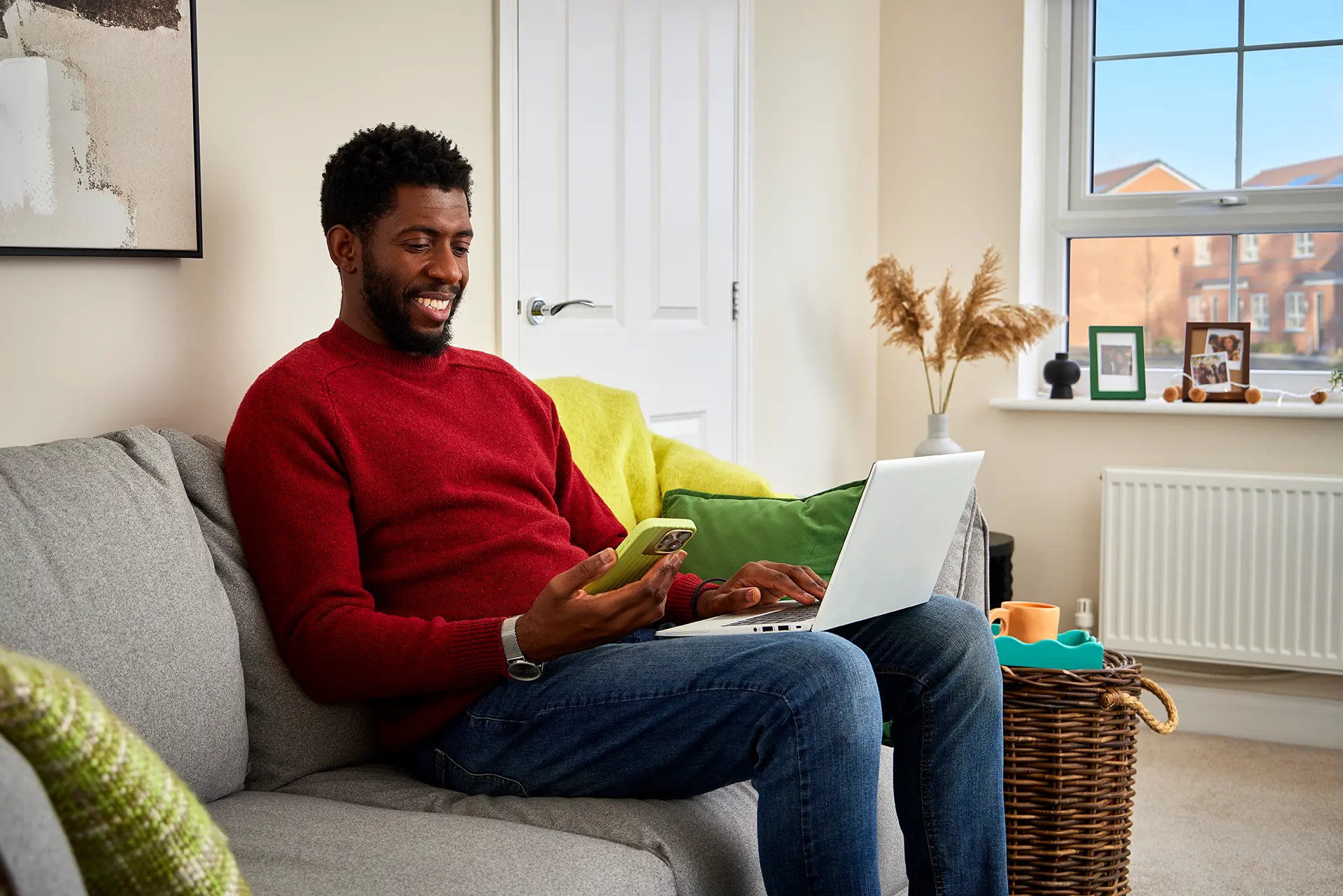 Man sitting on the couch looking at his phone